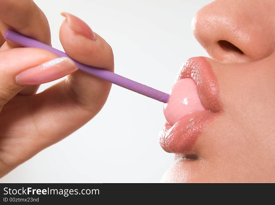 Young beautiful girl with lollipop in her mouth