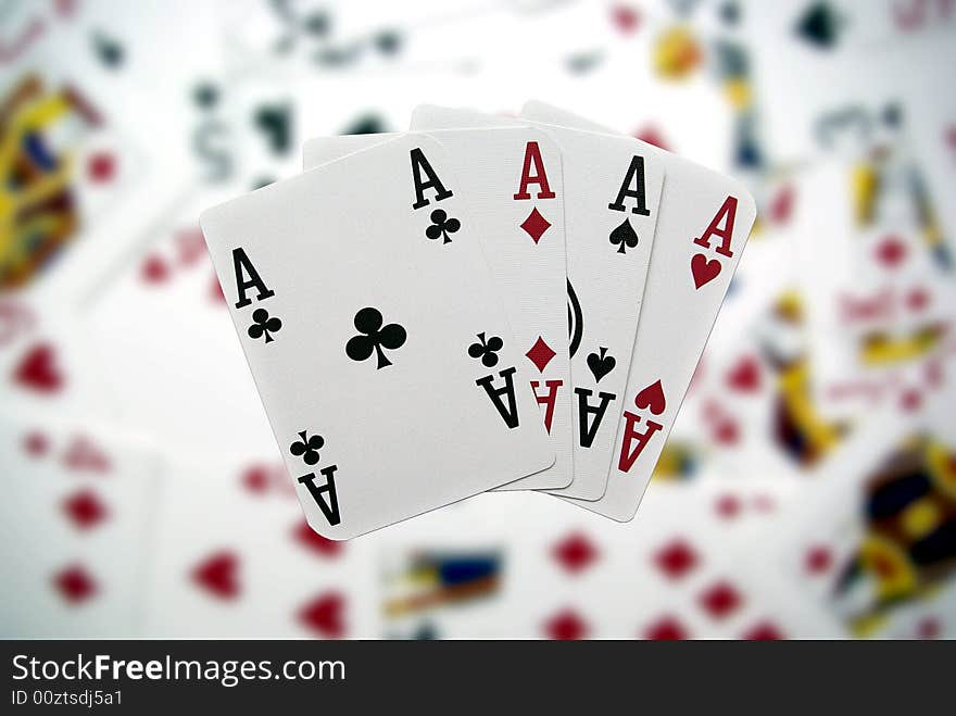 Poker cards showing a four-to-ace combination on a blurry background. Poker cards showing a four-to-ace combination on a blurry background