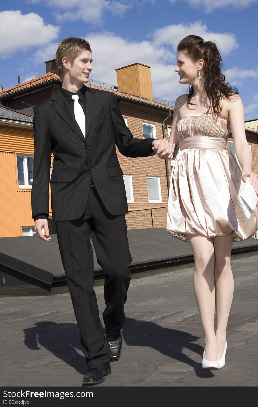 Young beautiful happy couple on the house roof. Young beautiful happy couple on the house roof