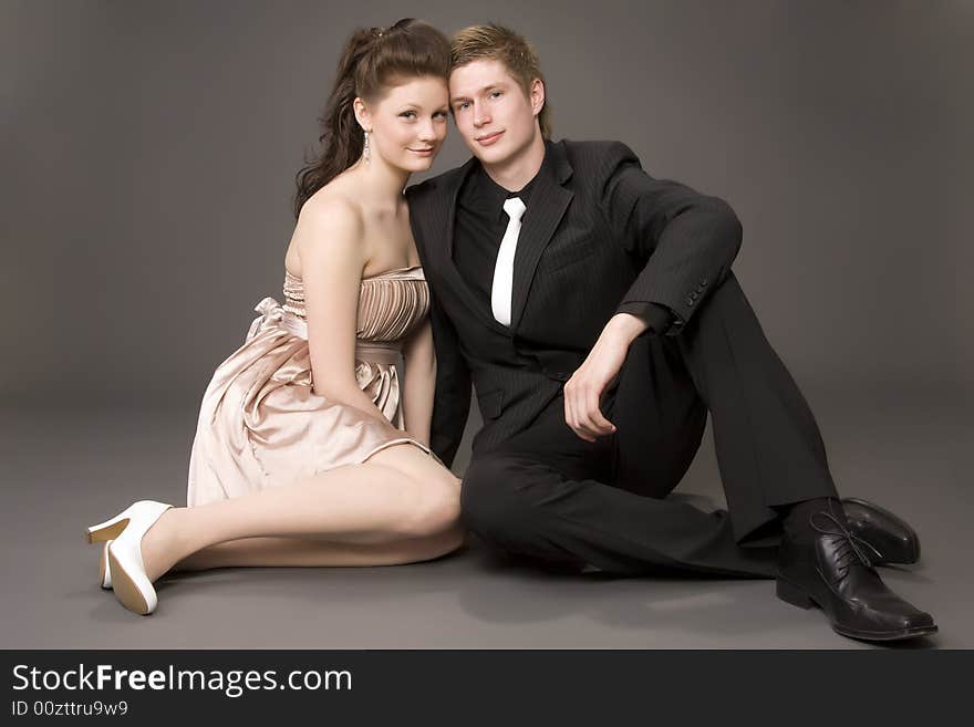 Portrait of a young beautiful couple on gray background