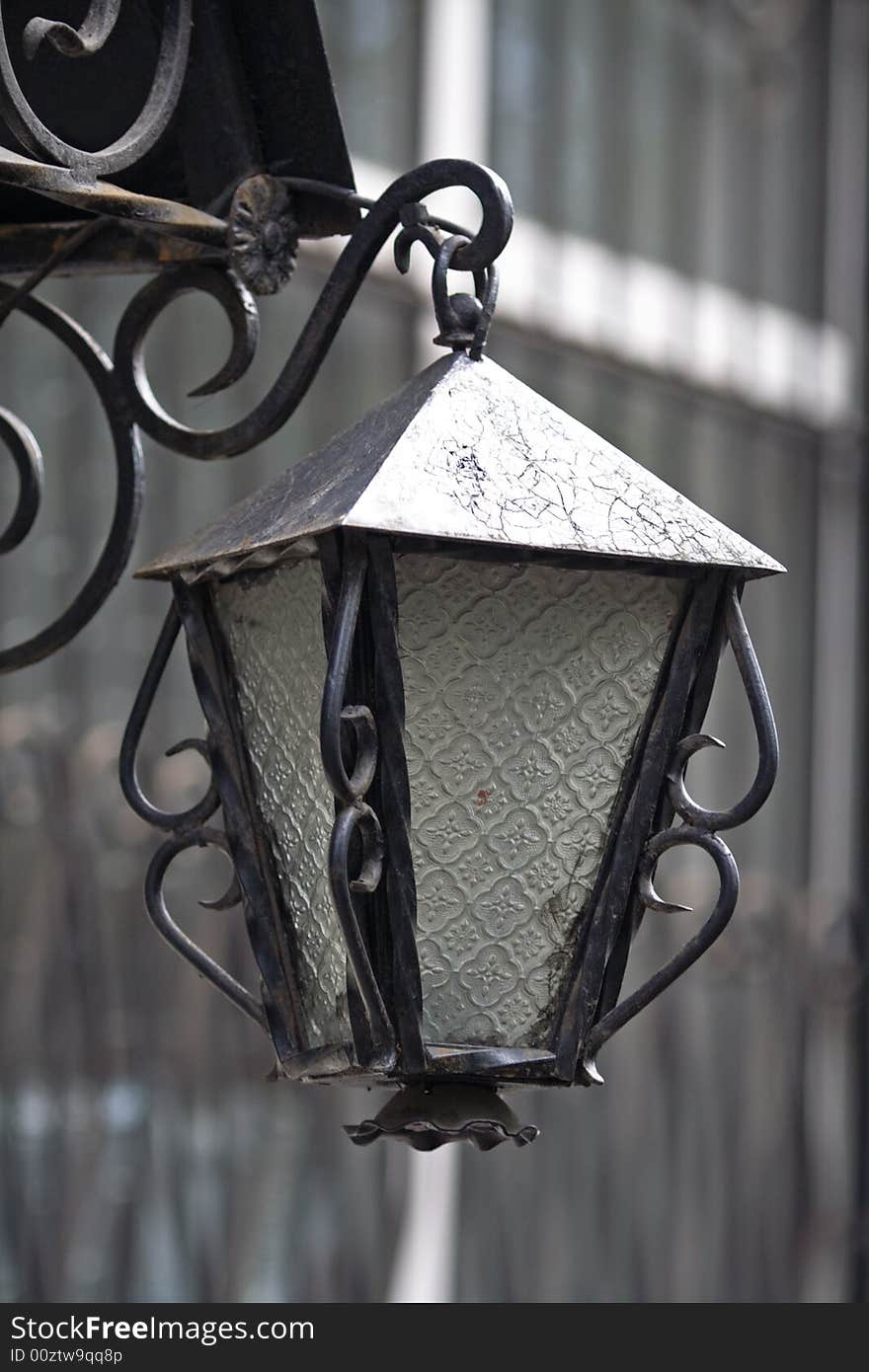 Lantern at the canopy of an old brick building, simulating an old, antique gas lantern.