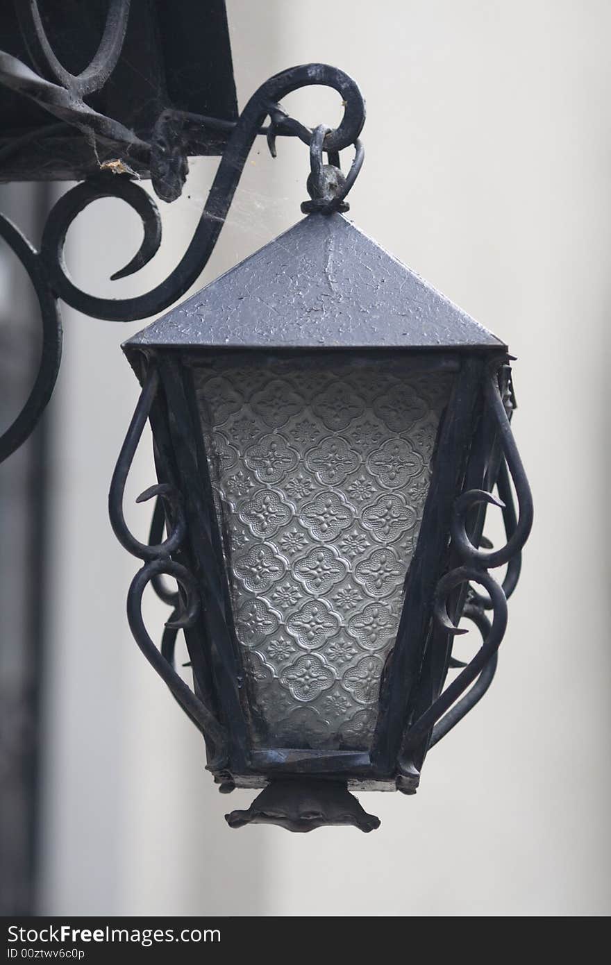 Lantern at the canopy of an old brick building, simulating an old, antique oil lantern.