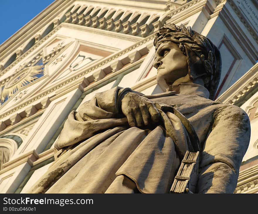 A wonderfull shot of the statue of Dante Alighieri and santa croce church in florence - Italy