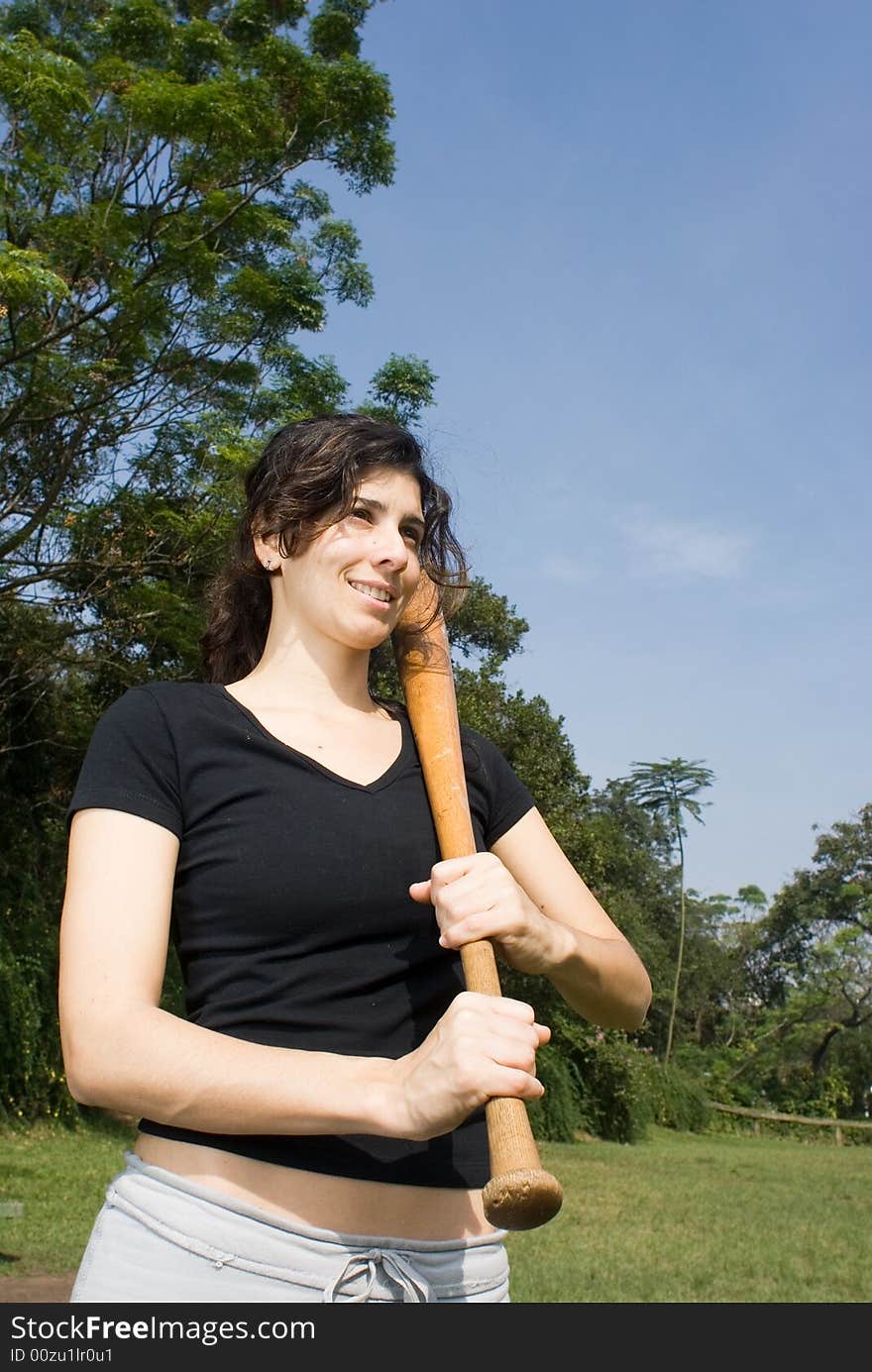 Woman Posing With Baseball Bat in Park - Vertical