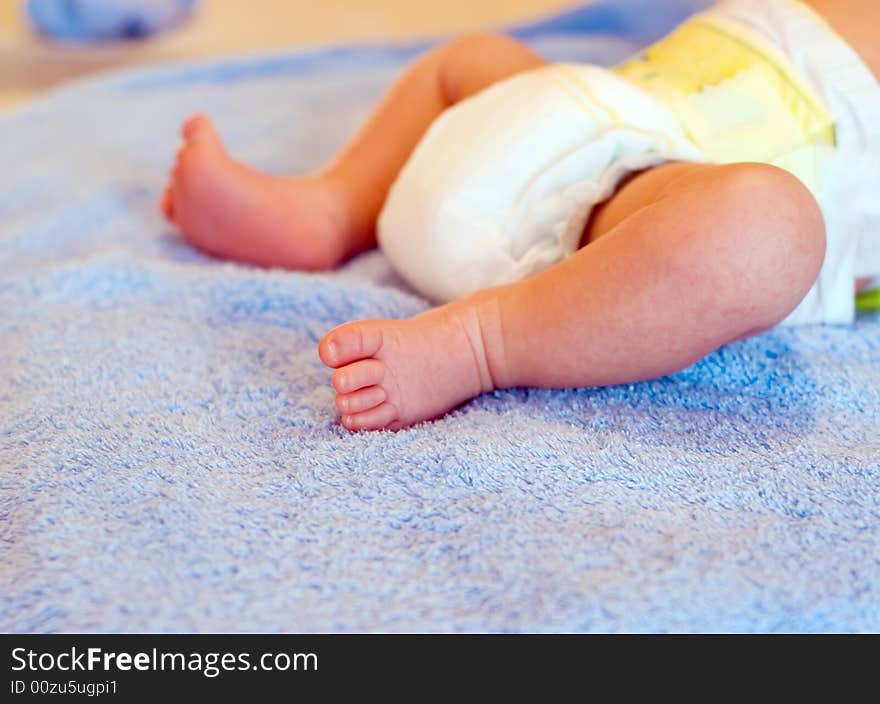 Newborn's legs on bathing towel before bath