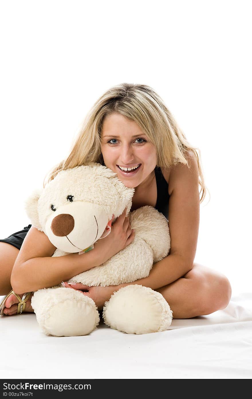 Close-up lovely young blonde girl with teddy bear isolated on white background