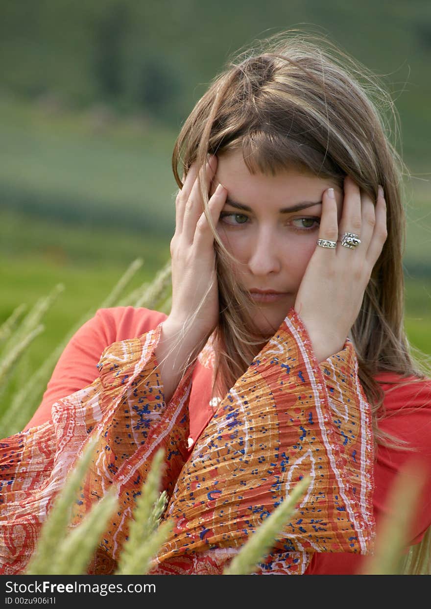 Thoughtful girl with hands near head