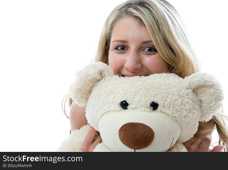 Happy little girl with teddy bear on a bedroom isolated on white background