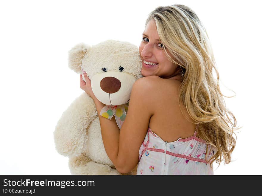 Happy sexy girl with teddy bear on a bedroom isolated on white background