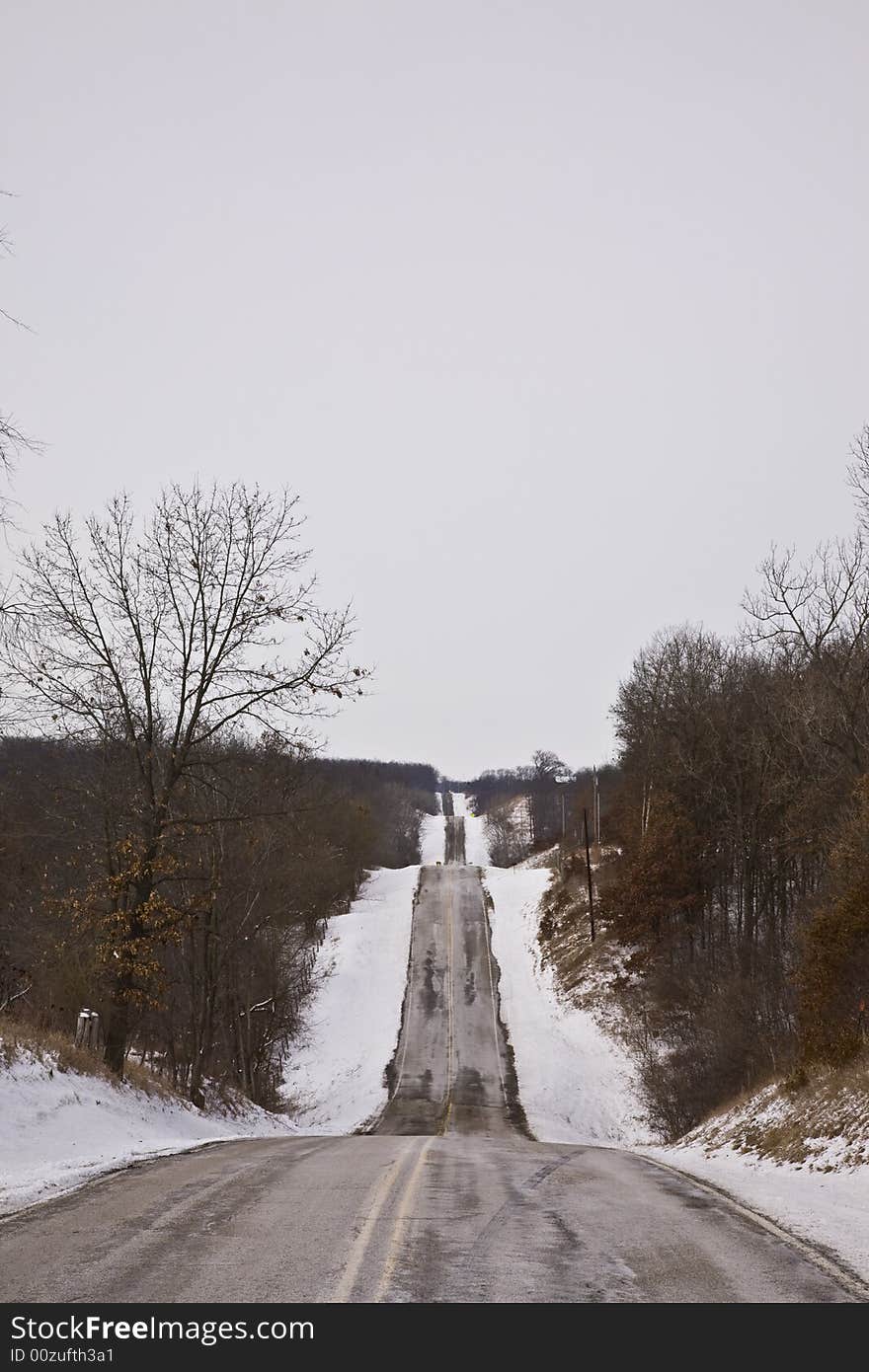 Vertical shot of rural midwestern road in winter. Vertical shot of rural midwestern road in winter