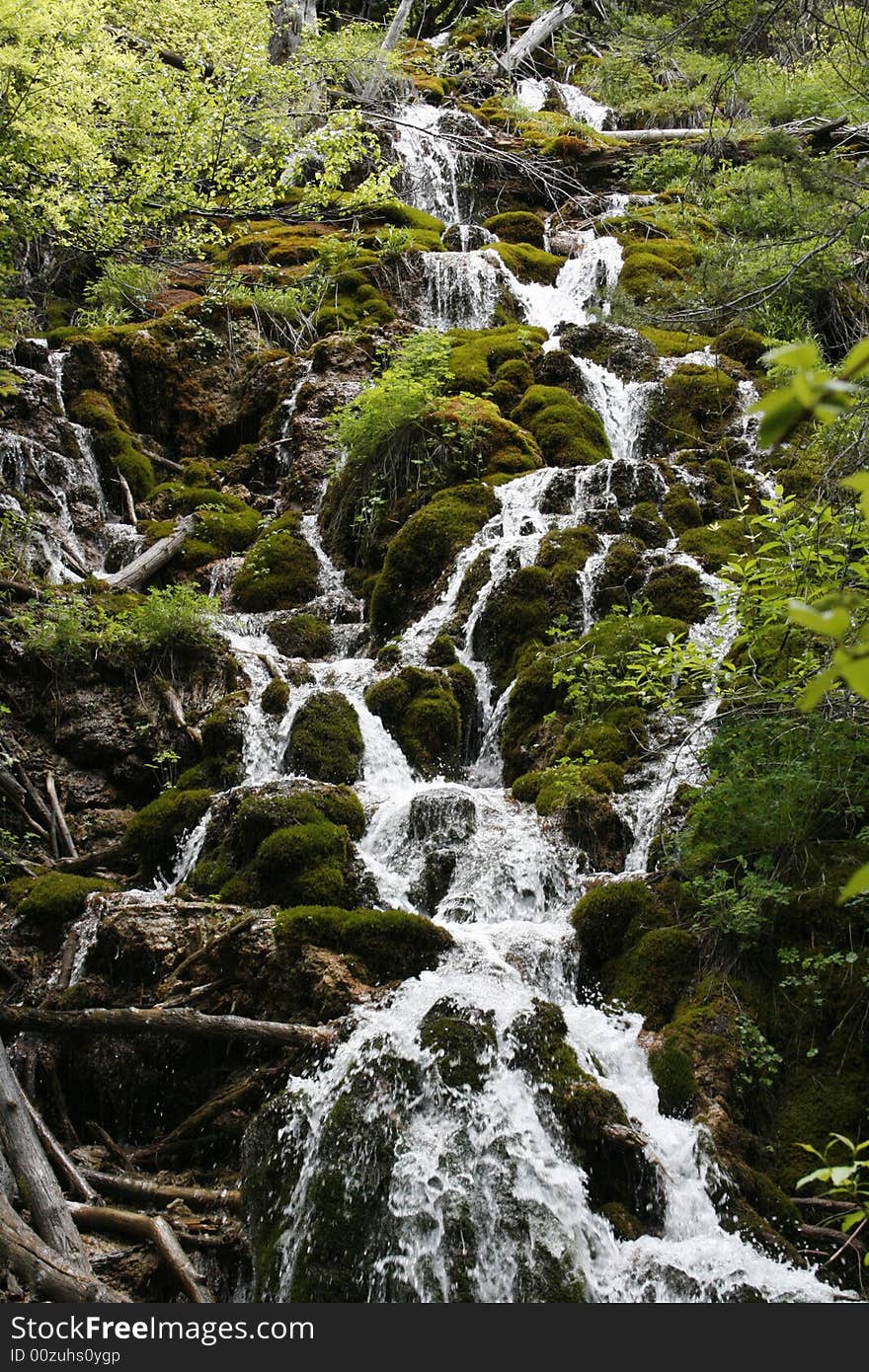 Waterfall over green moss covered rocks. Waterfall over green moss covered rocks.