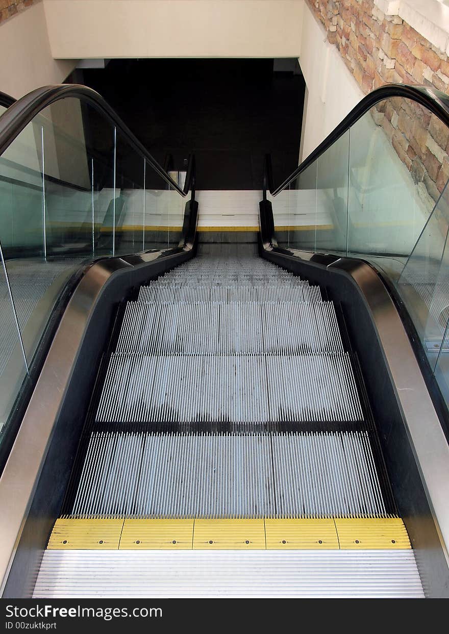 Stopped escalator heading down into a dark room. Stopped escalator heading down into a dark room