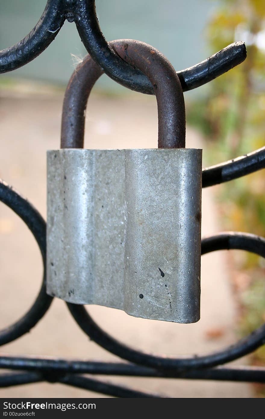 Old grunge lock on garden lattice year daytime