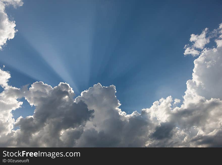 Beatiful sun rays in blue sky, downy clouds. Beatiful sun rays in blue sky, downy clouds