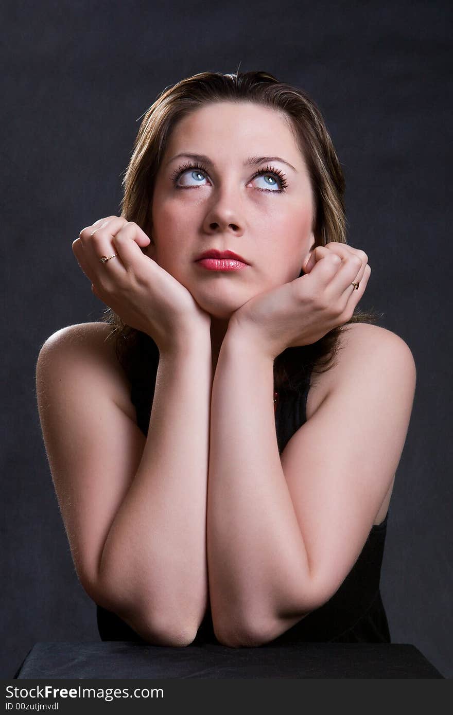 Portrait of the beautiful young girl on a dark background. Portrait of the beautiful young girl on a dark background