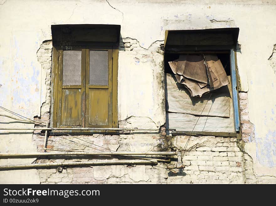 An old dilapidated beige building. An old dilapidated beige building