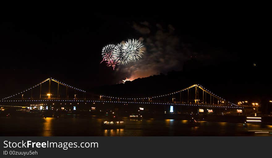 Fireworks in black sky over bridge in Kiev