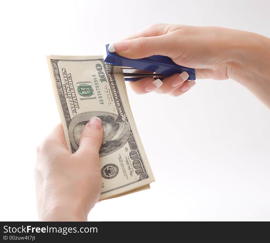 Female stapling us dollars, isolated