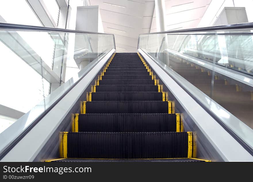 An image of an escalator with some motion blur