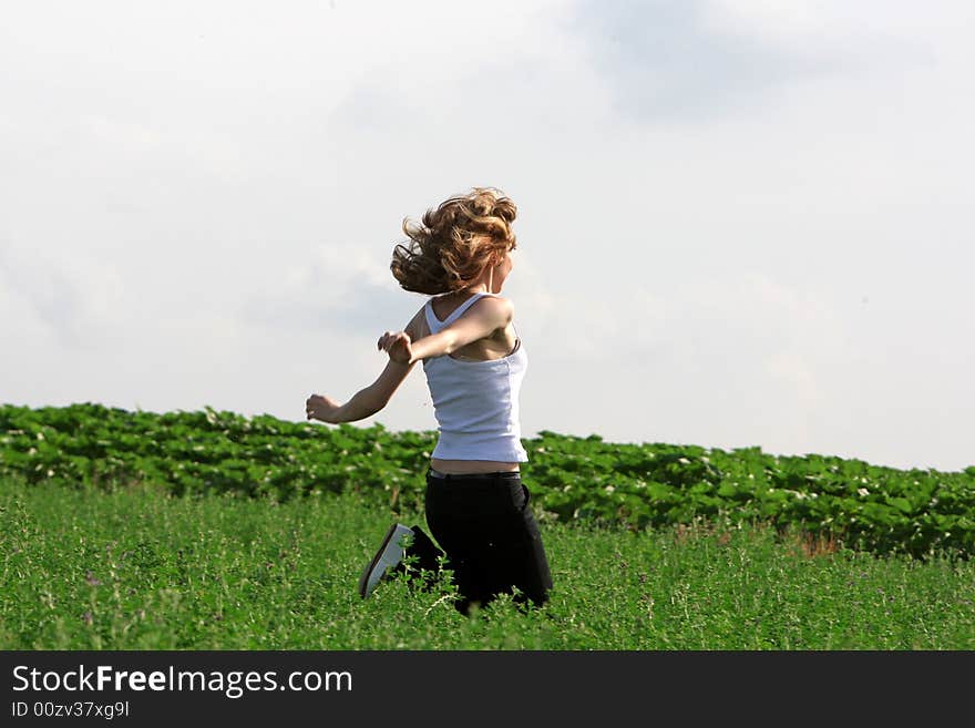 A beautiful girl running on the field