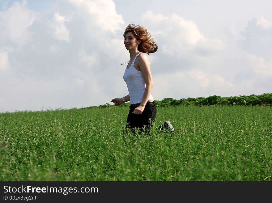 A beautiful girl running on the field