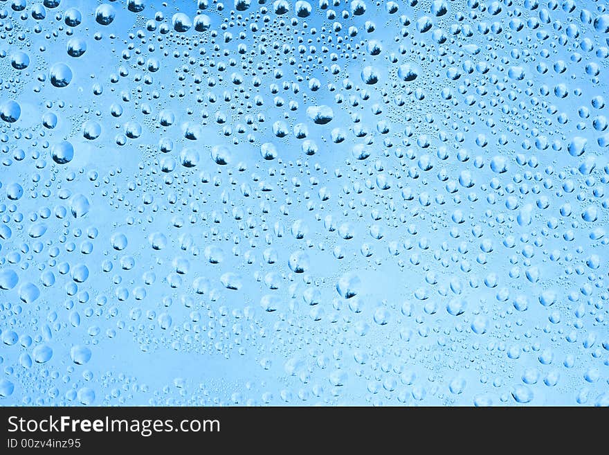 Rain drops on a window. Tree is visible in rain drops at full resolution. Rain drops on a window. Tree is visible in rain drops at full resolution.