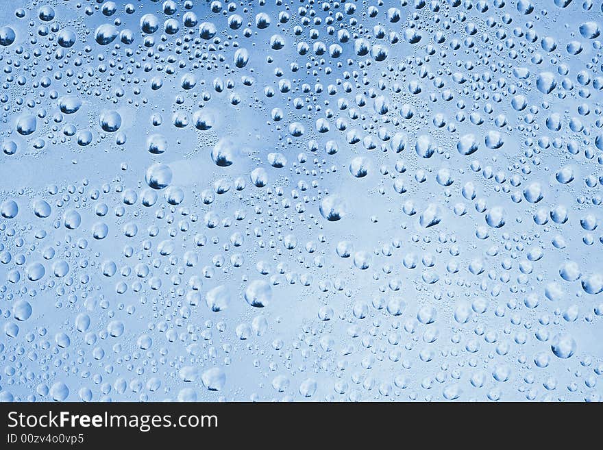 Rain drops on a window. Tree is visible in rain drops at full resolution. Rain drops on a window. Tree is visible in rain drops at full resolution.