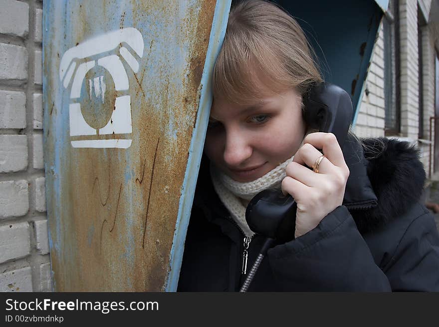 Upset urban girl with street phone. Upset urban girl with street phone