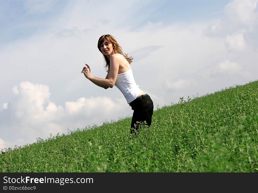 A beautiful girl jumping on the field