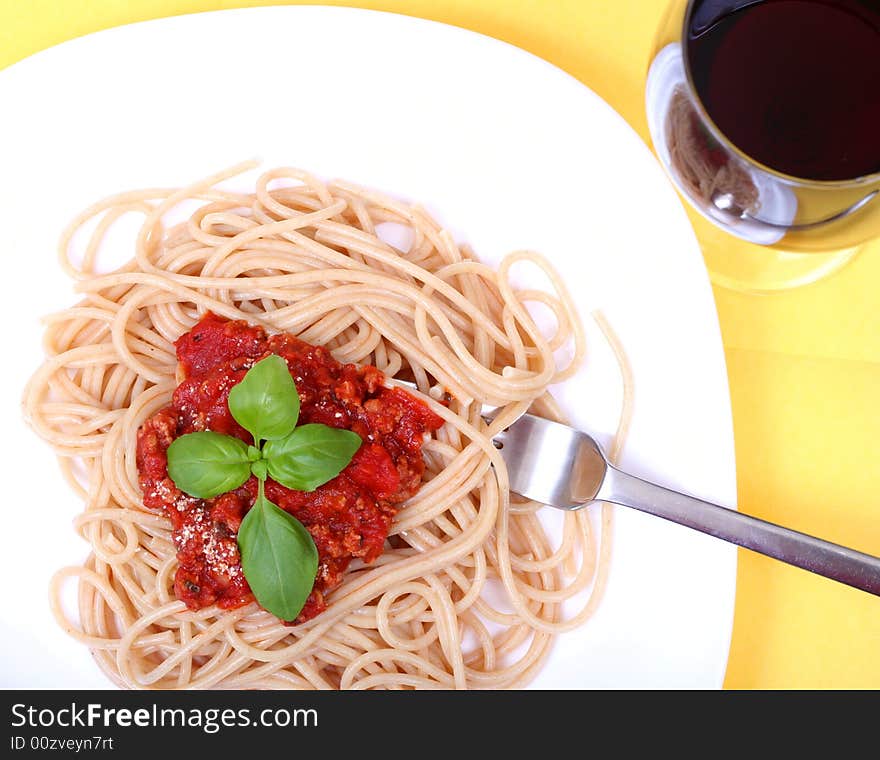 Spaghetti bolognes served on white plate and wine. Spaghetti bolognes served on white plate and wine