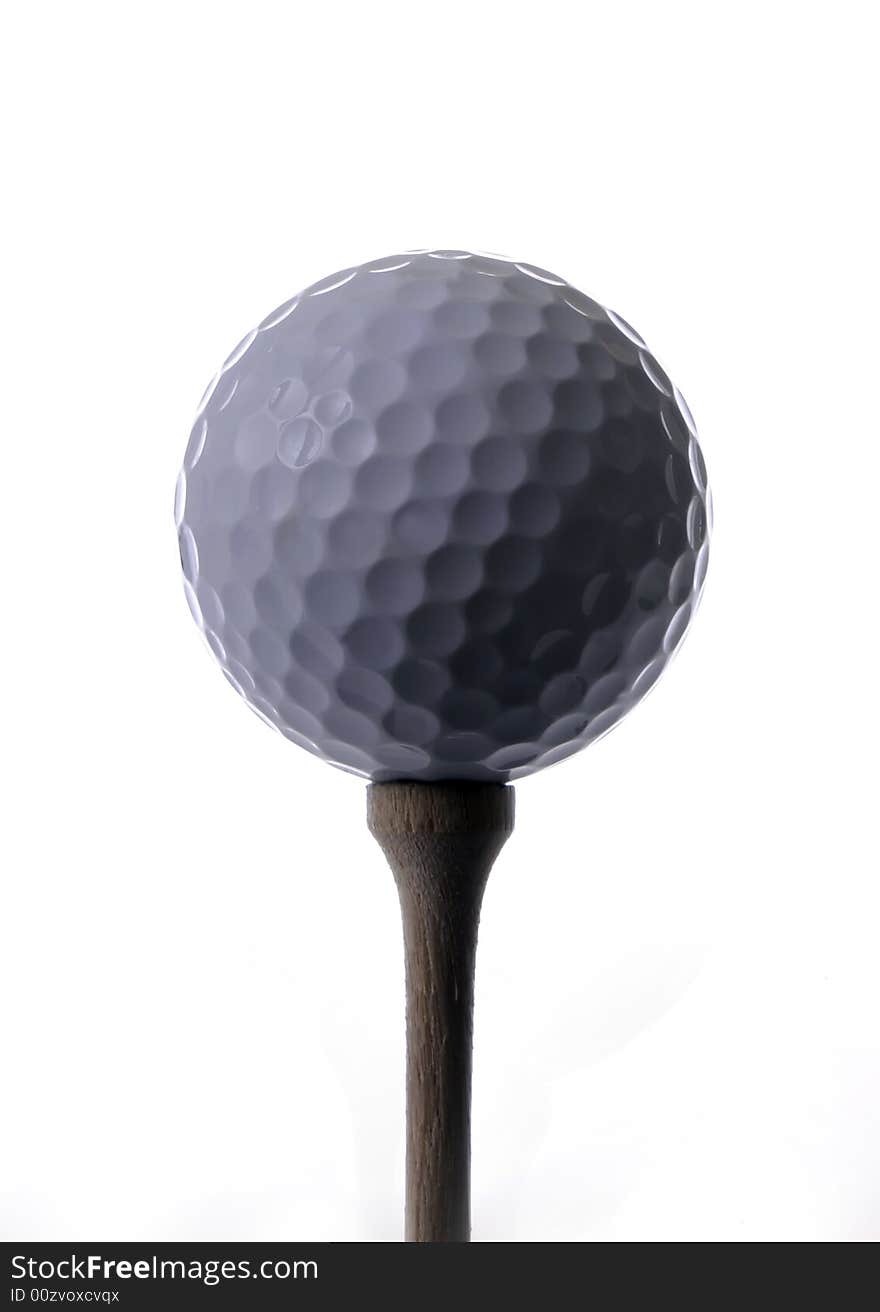 Golf ball on a tee with white background