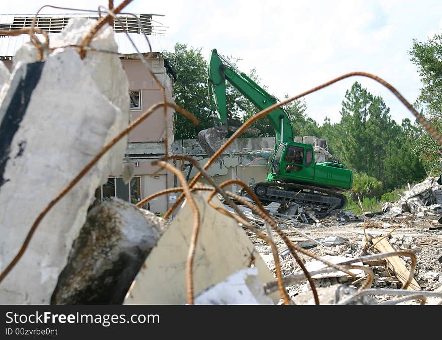 Medium weight shovel tearing down a building in preparation for construction. Medium weight shovel tearing down a building in preparation for construction.