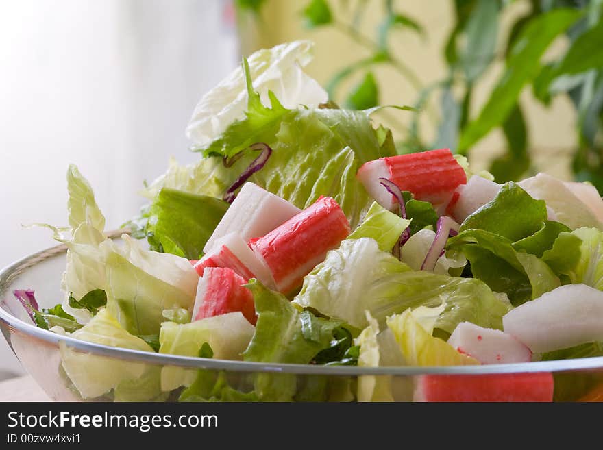 Crabstick salad with assorted salad leaf and onions