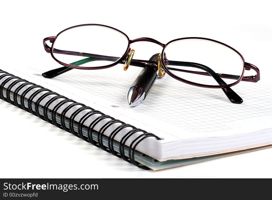 Notepad With Eyeglasses And Pen Isolated