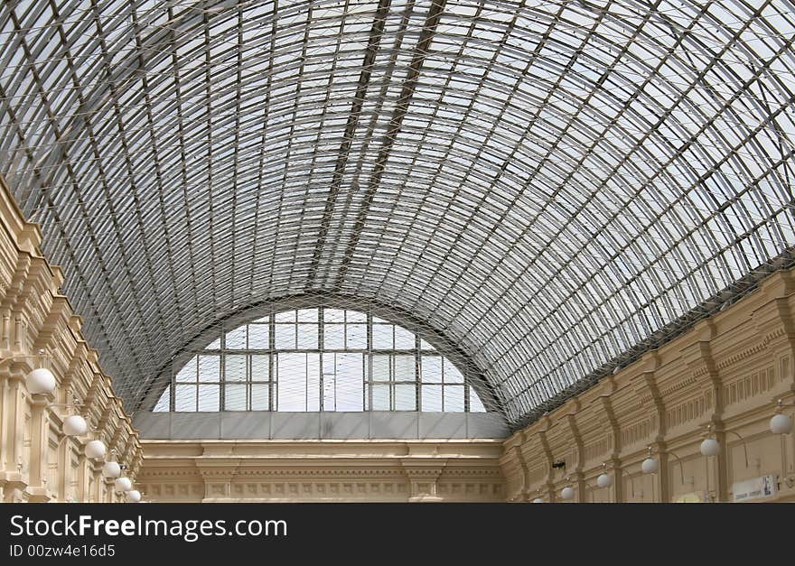 Interior of shopping center with a kind on a glass roof. Interior of shopping center with a kind on a glass roof.