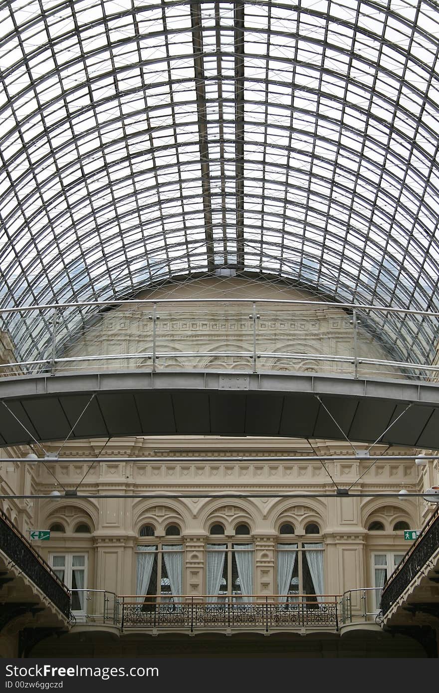 Interior of shopping center with a kind on a glass roof. Interior of shopping center with a kind on a glass roof.