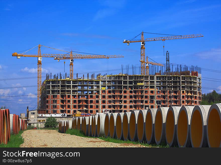 Concrete pipes for construction of new sewer system. Construction of a complex of buildings