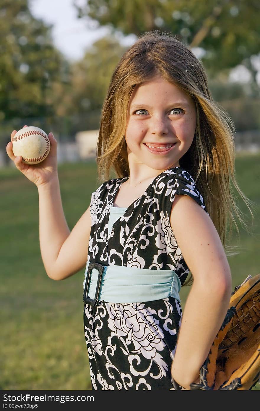 Cute young girl with a baseball