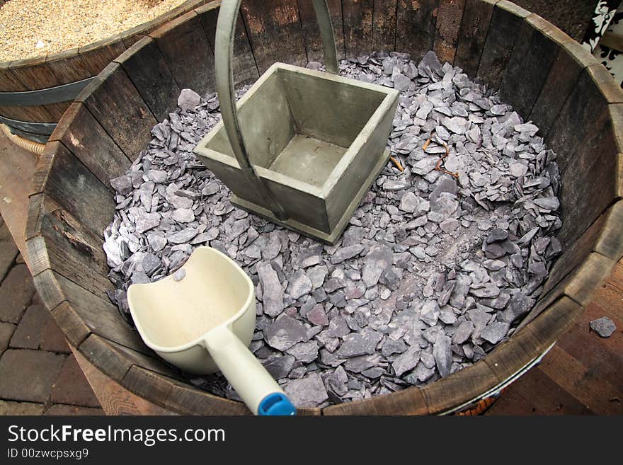 Stone bits in a treebucket with a scoop. Stone bits in a treebucket with a scoop