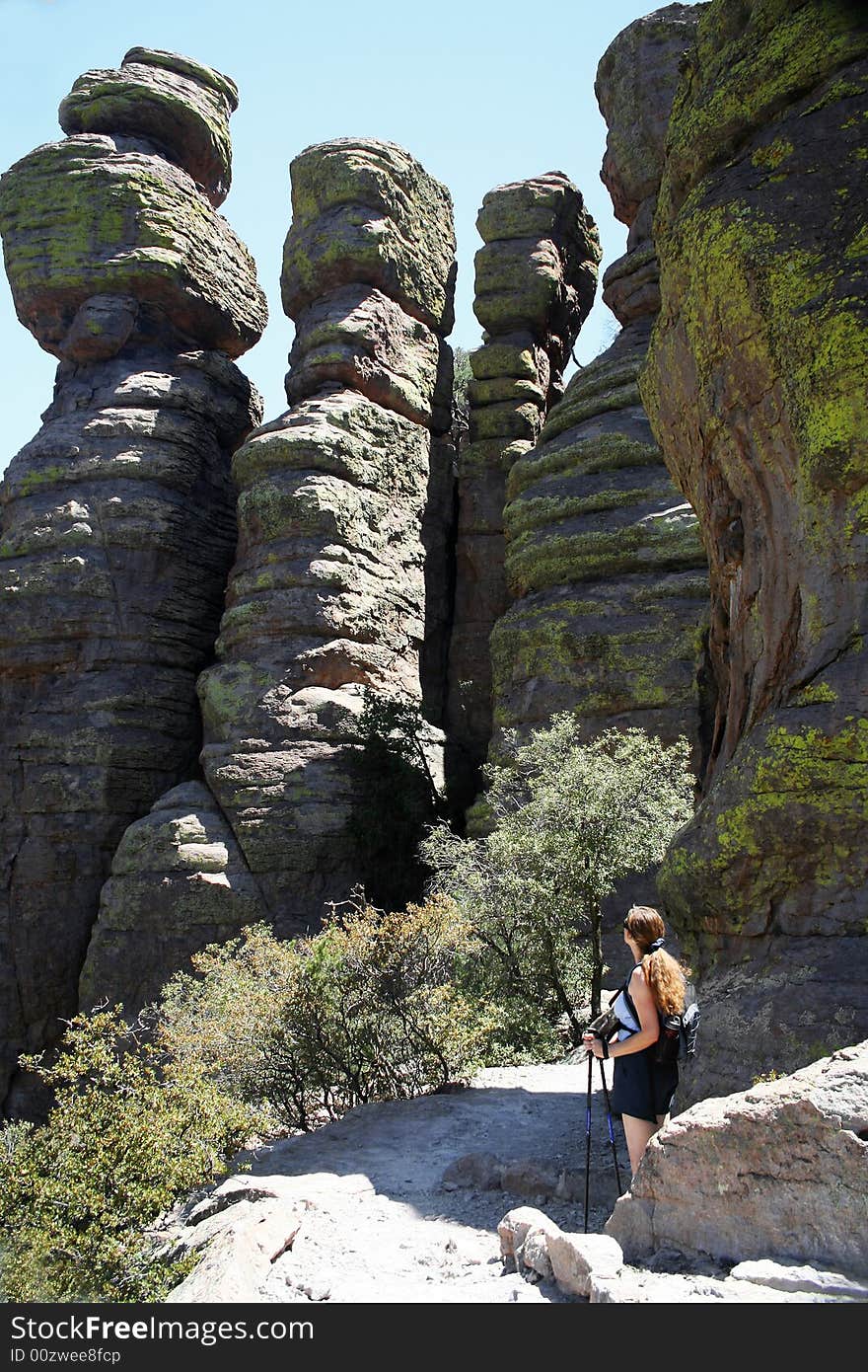 A Woman on a Hike Pauses Amongst the Weird Pinnacles Called 'Standing Up Rocks' Along the Echo Canyon Trail, Chiricahua National Monument, Arizona. A Woman on a Hike Pauses Amongst the Weird Pinnacles Called 'Standing Up Rocks' Along the Echo Canyon Trail, Chiricahua National Monument, Arizona