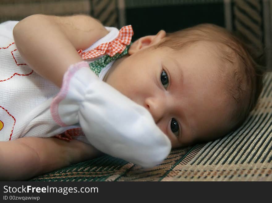 Portrait of the newborn girl wrapped up in diapers