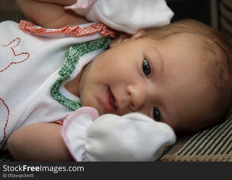 Portrait of the newborn girl wrapped up in diapers