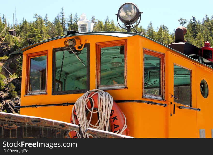 Small wheel house on a yellow tugboat. Small wheel house on a yellow tugboat