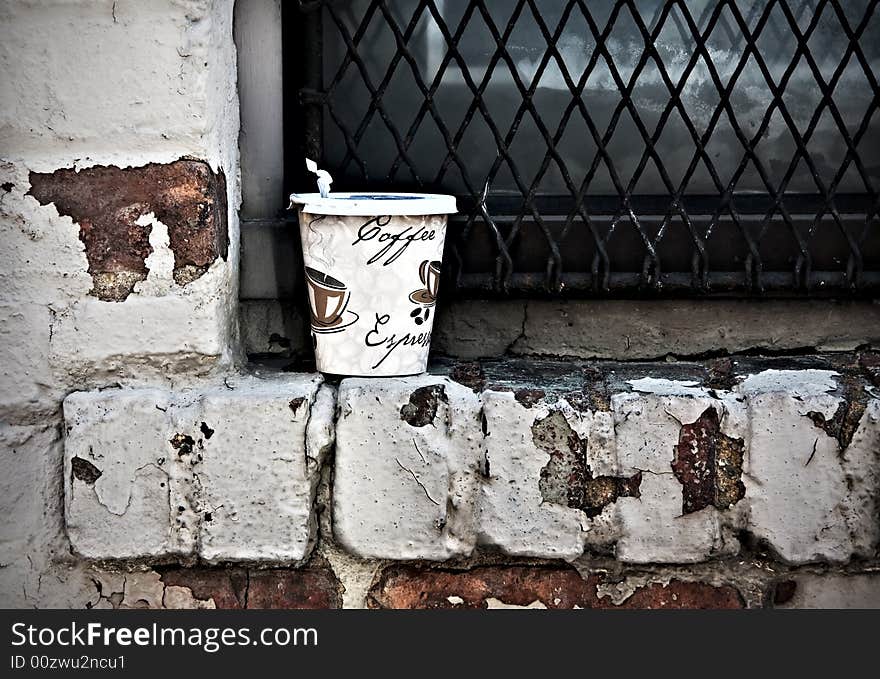 Closeup of discarded coffee cup on windowsill