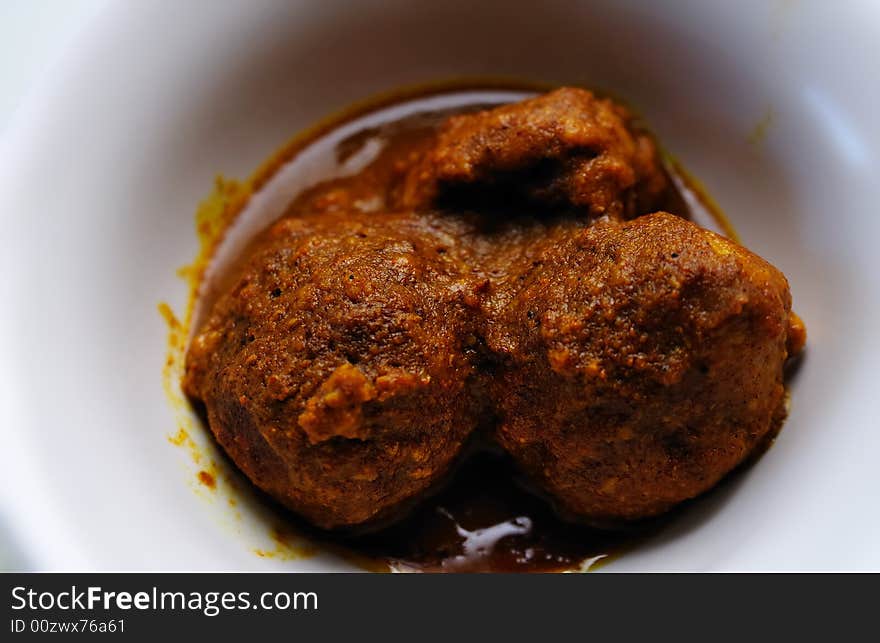 Close shot of a pair of curry meat balls. Close shot of a pair of curry meat balls.