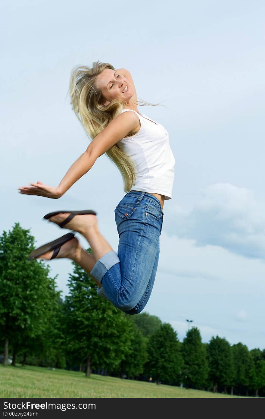 Happy jumping woman in the park. Happy jumping woman in the park.