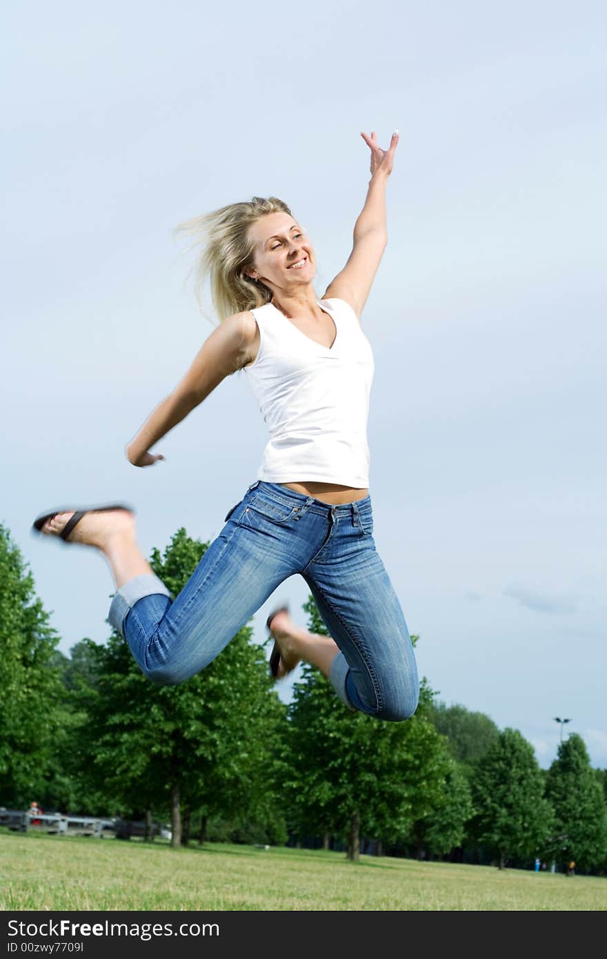 Happy jumping woman in the park. Happy jumping woman in the park.