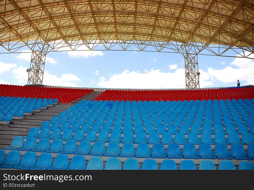 A man walking on the stadium. A man walking on the stadium