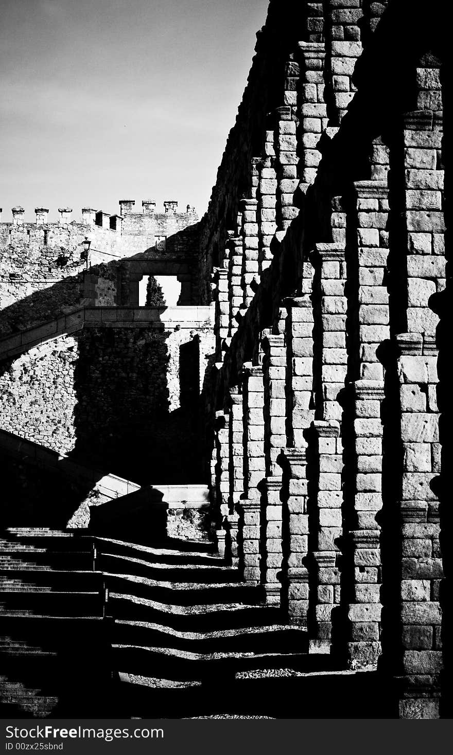 Archways with cascading shadows in black and white and shot at a dramatic angle. Archways with cascading shadows in black and white and shot at a dramatic angle.