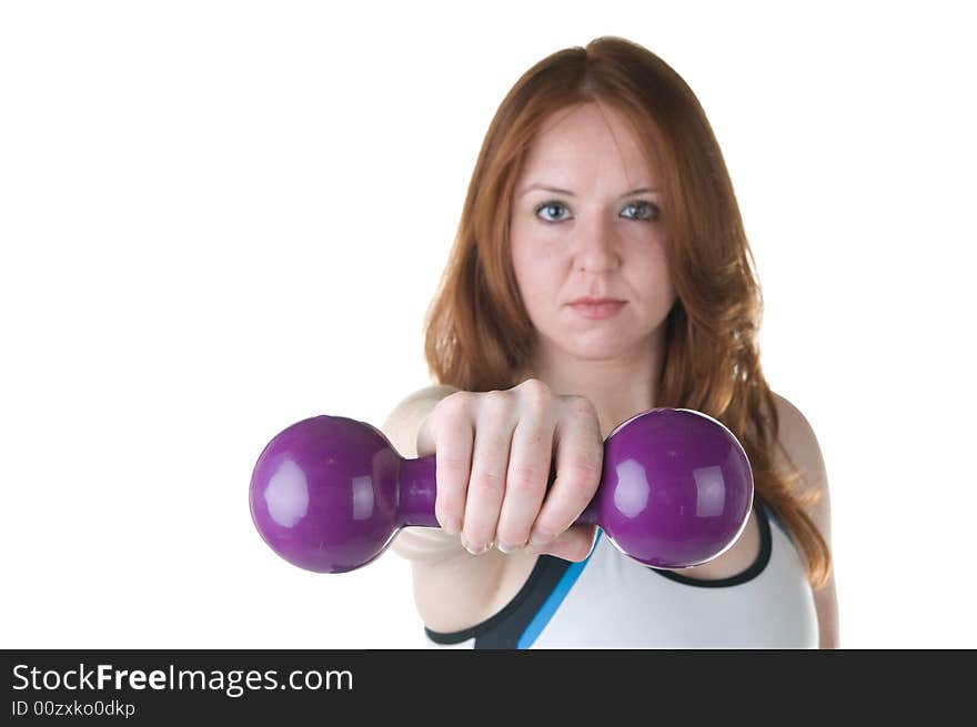 Pretty young red haired woman with focus on hand and weights. Pretty young red haired woman with focus on hand and weights